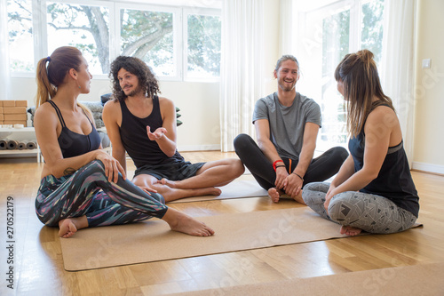 Fotografie Happy students chatting after yoga class