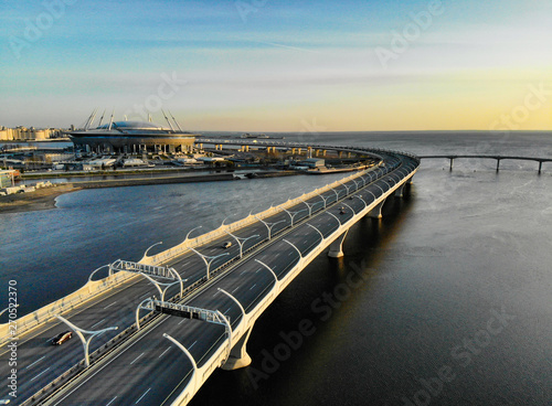 8 may 2019, St. PETERSBURG Russia: Aerial view of Football stadium Zenit Arena at sunset and new road - Western High Speed Diameter connecting Krestovsky and Vasilyevsky Islands. Viaduct above Neva. photo