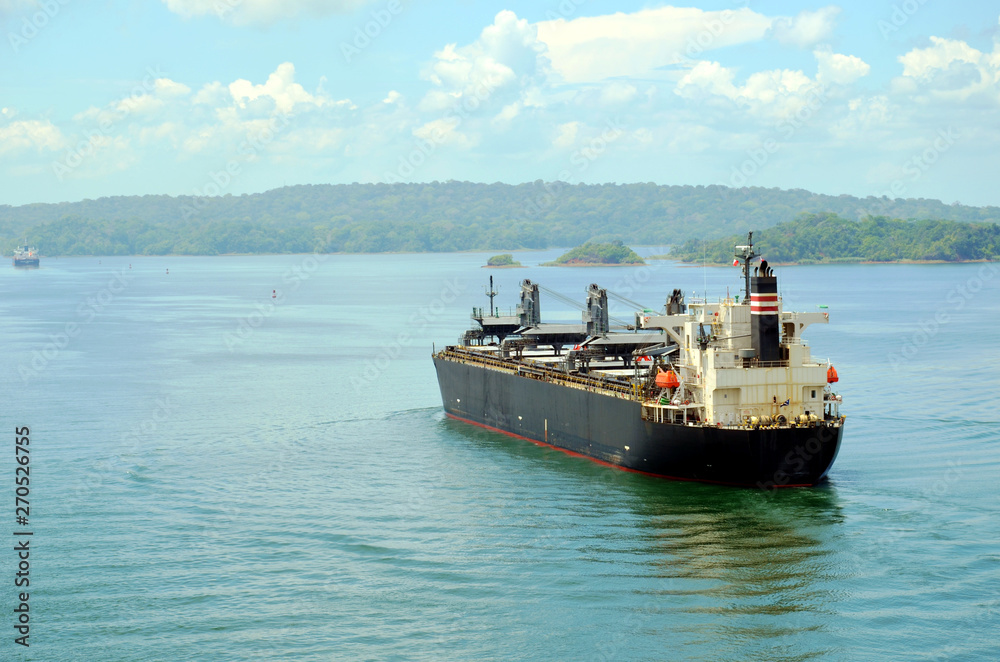 Cargo ship transiting through Panama Canal. 