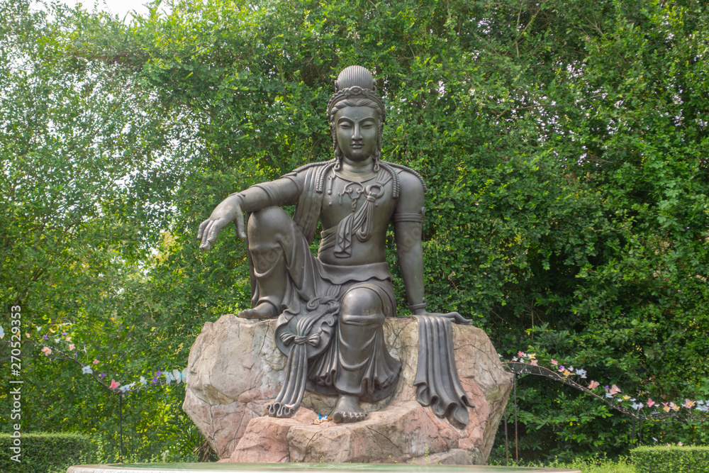 The Avalokitesvara Bodhisattva Buddha statue is in garden that is a graceful and respectable