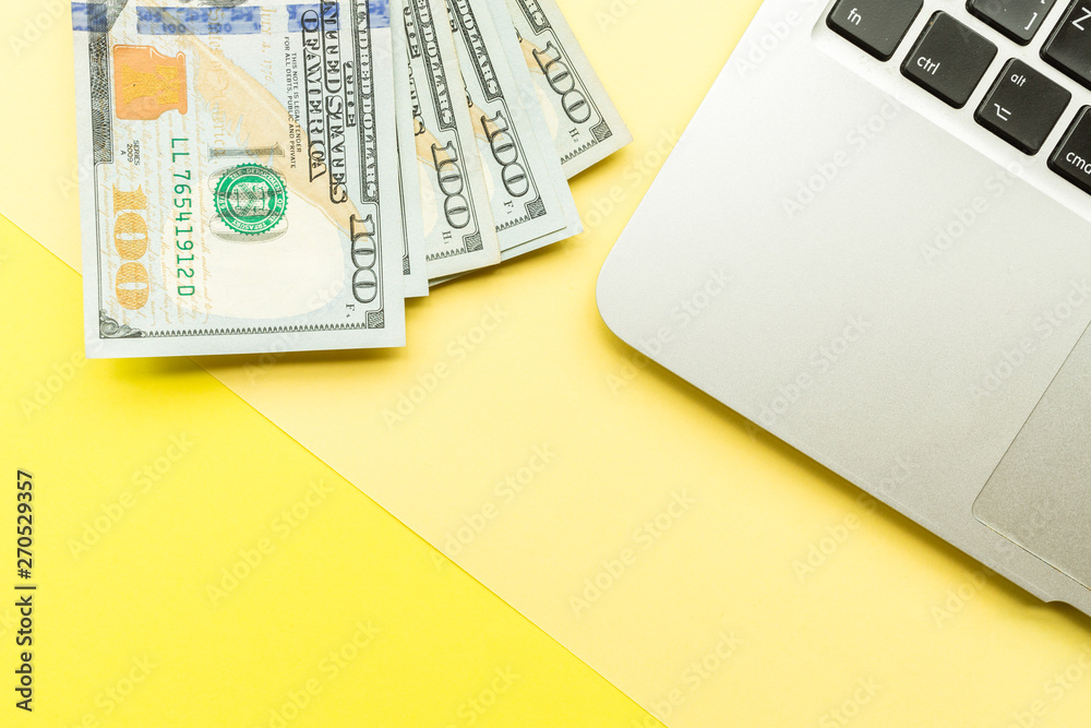 Mockup Blank page with laptop and cash money on yellow background. Top view with copy space for input the text. Flat lay, business concept Mockup Blank page with laptop and cash money on yellow background. Top view with copy space for input the text. Flat lay, business concept