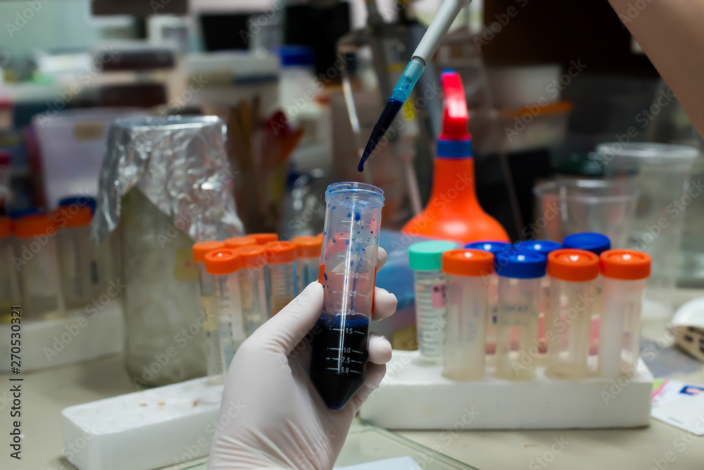 lab technician assistant analyzing a blood sample in test tube at laboratory. lab technician assistant analyzing a blood sample in test tube at laboratory.