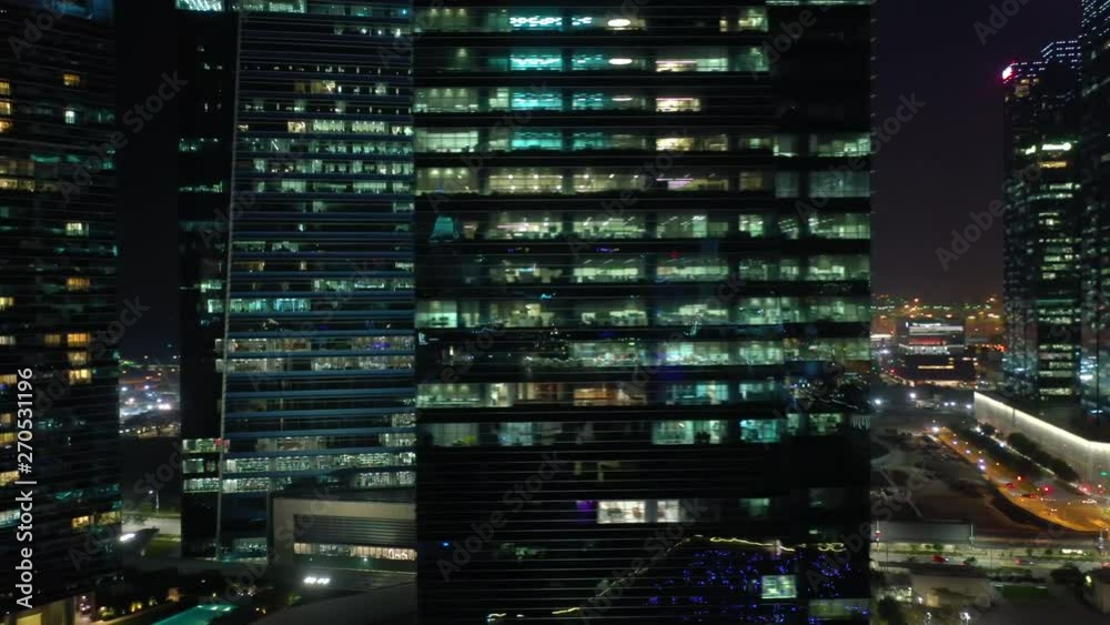 night time illumination singapore downtown buildings front aerial panorama 4k 