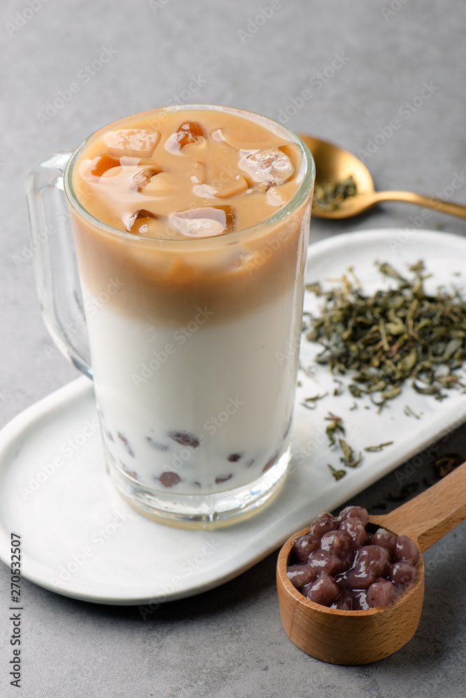 Oolong tea mixed with fresh milk in a clean glass Oolong tea mixed with fresh milk in a clean glass