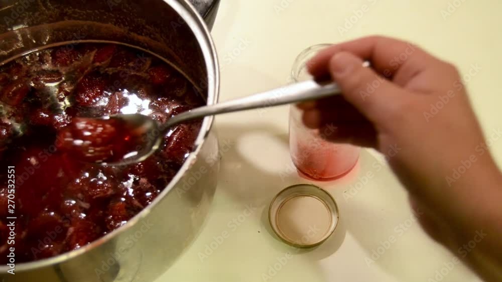 Woman Puts Handmade Strawberry Jam In Jar Woman Puts Handmade Strawberry Jam In Jar