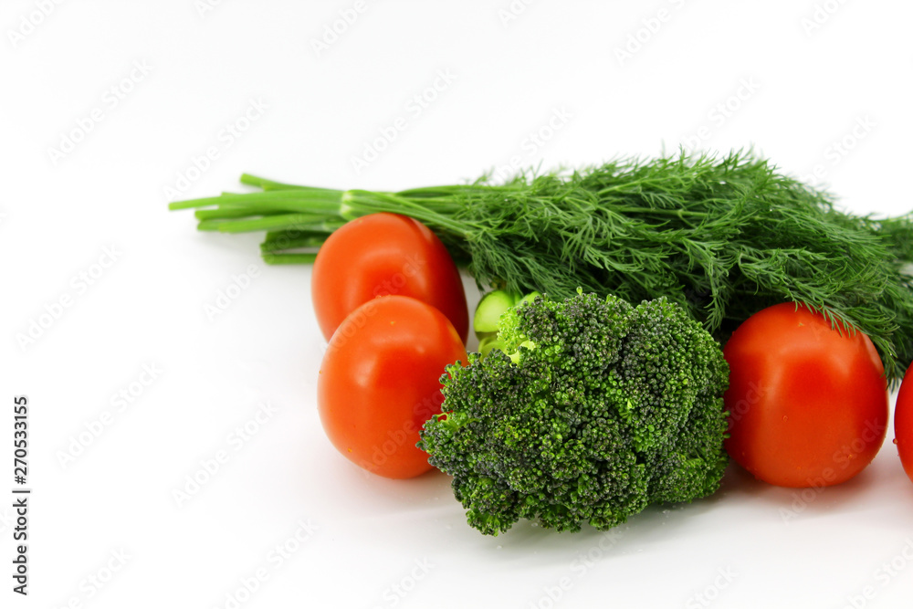 Vegetables and greens on white background. Red tomatoes, broccoli, fennel bunch Vegetables and greens on white background. Red tomatoes, broccoli, fennel bunch