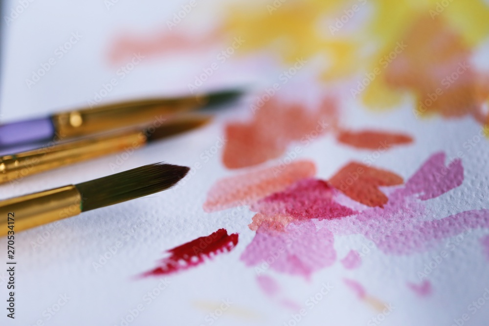 Fototapeta premium Painting brush and watercolor paper closeup