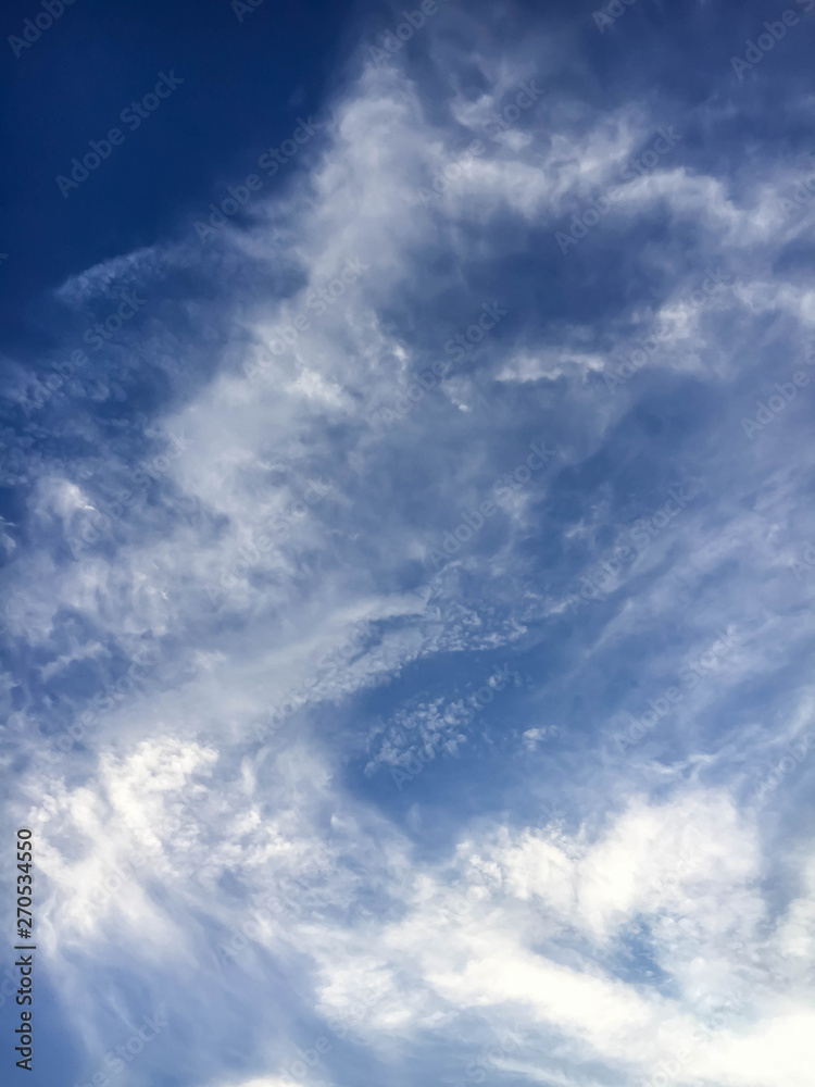 blue sky background with tiny clouds