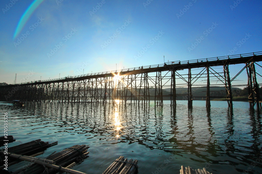 wooden pier at sunset in Sangkla Buri Thailand