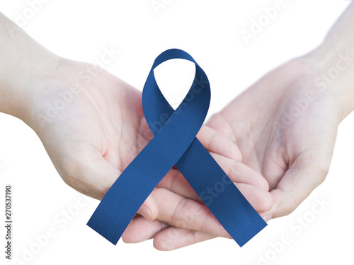 Royal dark navy blue ribbon awareness in hand for Arthritis, Chronic Fatigue Syndrome, Colitis, Colon, Colorectal Cancer isolated on white background with clipping path. photo