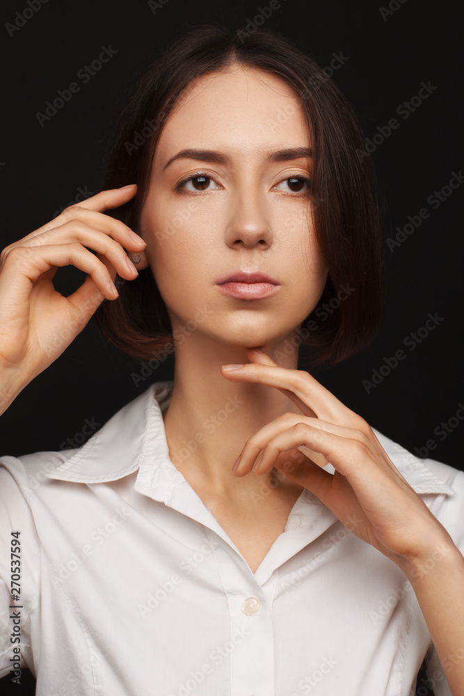 Portrait of a beautiful pacified woman in a white shirt on a light background Portrait of a beautiful pacified woman in a white shirt on a light background