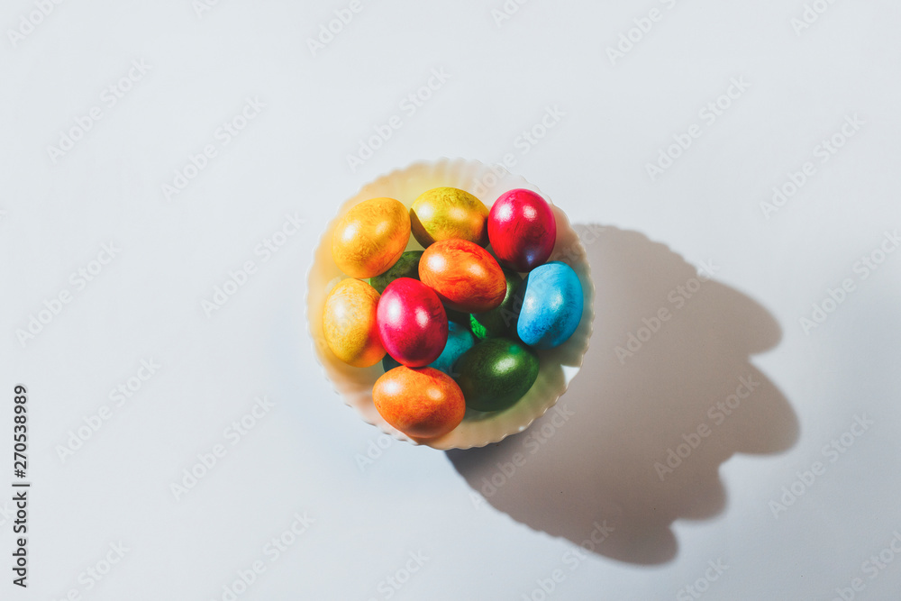 Plate with easter eggs on a light background. Easter celebration concept Plate with easter eggs on a light background. Easter celebration concept
