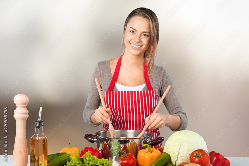 Young beautiful woman Cooking in kitchen Young beautiful woman Cooking in kitchen