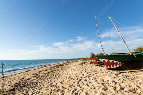 Traditional wooden fishing boats on the tropical beach of Anakao, Tulear, Madagascar.  Ocean view with sandy beach and clouds  photo