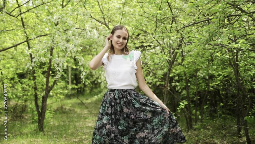 young girl posing, dancing and fooling around in front of blooming garden, blooming Apple trees, summer, spring, beautiful nature young girl posing, dancing and fooling around in front of blooming garden, blooming Apple trees, summer, spring, beautiful nature