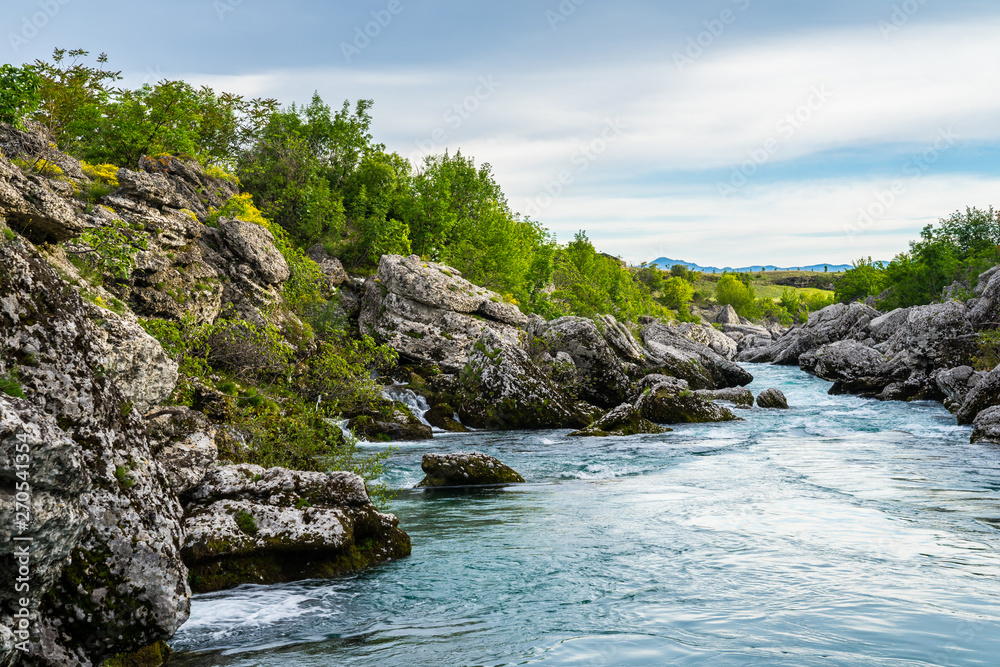 Montenegro, River cijevna near podgorica at niagara falls flowing through rocky stream course and green trees