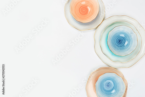 Set of colored ceramic plates on white background