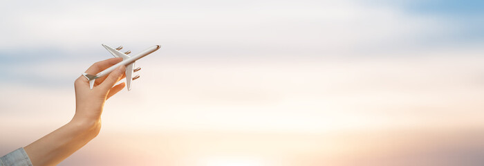 Woman holding airplane in hands