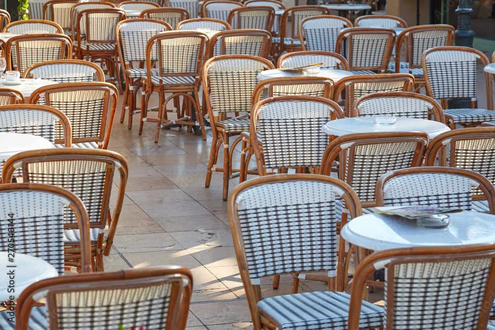 Outdoor cafe tables and chairs in a sunny summer day