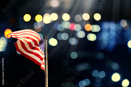 Conceptual image of waving American flag over abstract lights