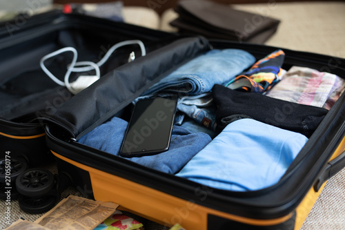 men's clothing packed in a suitcase