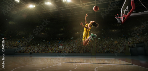Female basketball player makes slam dunk. Basketball player on big professional arena during the game © Alex