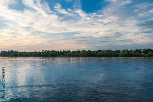 Danube delta landscape, blue waters white puffy clouds, and blue sky