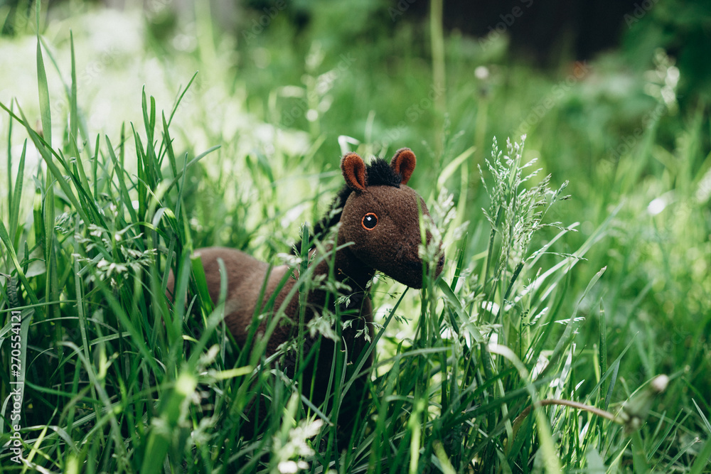 plush toy horse grazing in the grass plush toy horse grazing in the grass