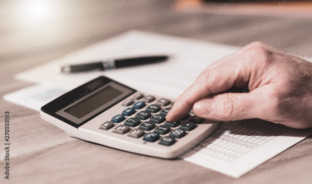 Hand using calculator, accounting concept Hand using calculator, accounting concept