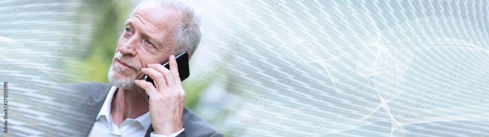 Mature man talking on mobile phone; panoramic banner Mature man talking on mobile phone; panoramic banner