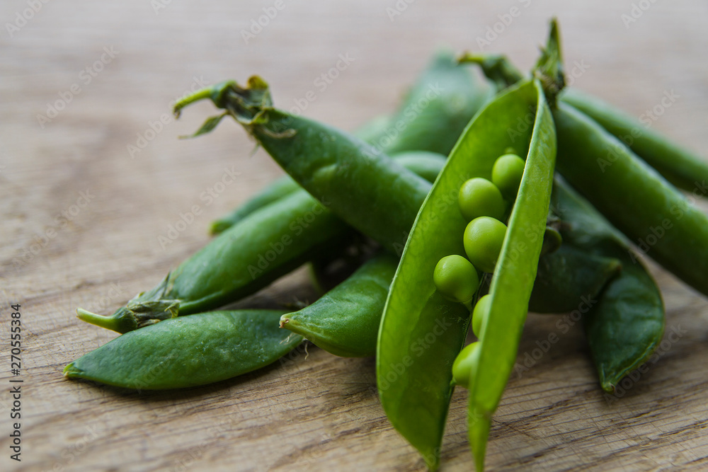 on wooden board lies green peas on wooden board lies green peas