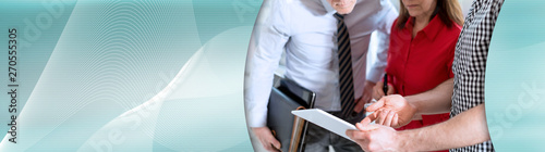 Business people in meeting working on tablet; panoramic banner