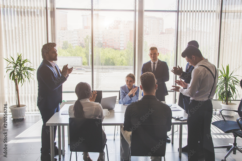 A team of young businessmen working and communicating together in an office. Corporate businessteam and manager in a meeting. A team of young businessmen working and communicating together in an office. Corporate businessteam and manager in a meeting.