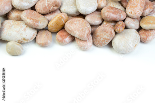 Small sea stones, isolated on white. Top view with copy space