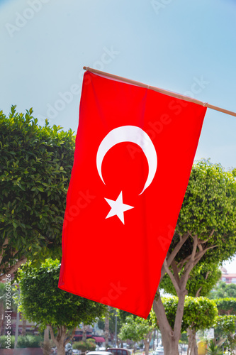 Photography Flag of turkey waving in front of the tropical street