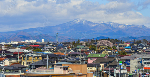 Cityscape with snow mountain in sunny day