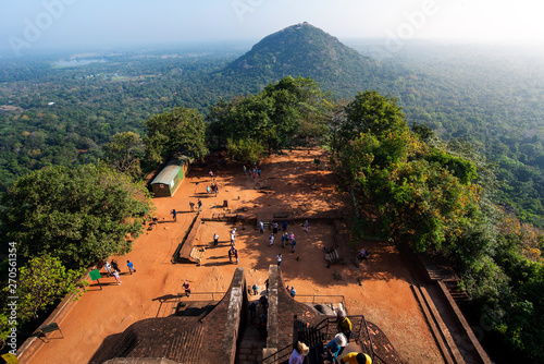 Sigiriya ancient Lion rock fortress in Sri Lanka with tourists photo