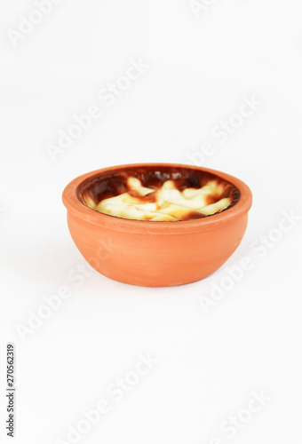 Turkish traditional sweet supangle dish in a clay plate on a white background 