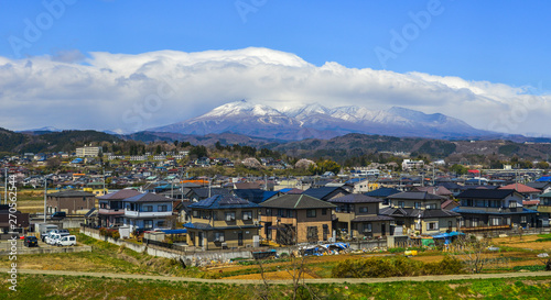 Cityscape with snow mountain in sunny day