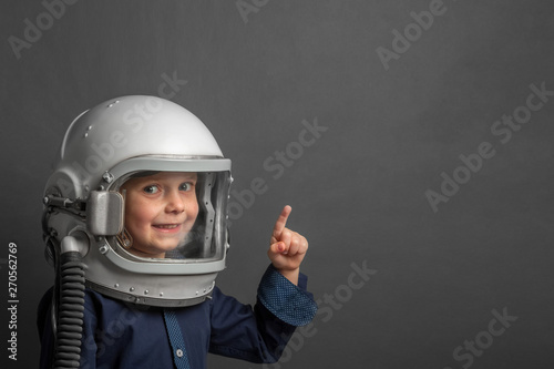 Small child wants to fly an airplane wearing an airplane helmet © vovan