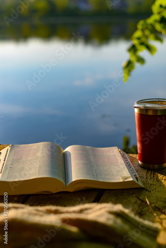 Devotional time outdoors: the Bible and a travel mug