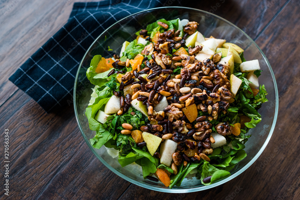 Pine Nut Salad with Walnut, Pear, Dried Apricot, Arugula or Rucola Leaves in Glass Bowl. Pine Nut Salad with Walnut, Pear, Dried Apricot, Arugula or Rucola Leaves in Glass Bowl.