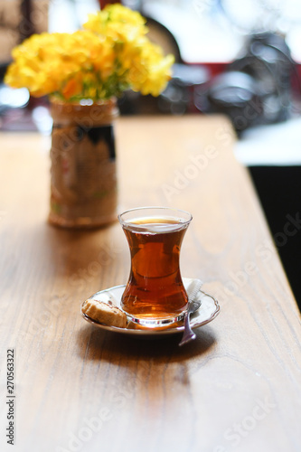 Tea in traditional turkish glass on a table