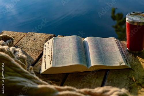 Devotional time outdoors: the Bible and a travel mug