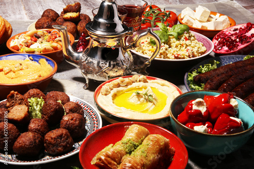 Middle eastern or arabic dishes and assorted meze  concrete rustic background. Falafel. Turkish Dessert Baklava with pistachio. Halal food. Lebanese cuisine