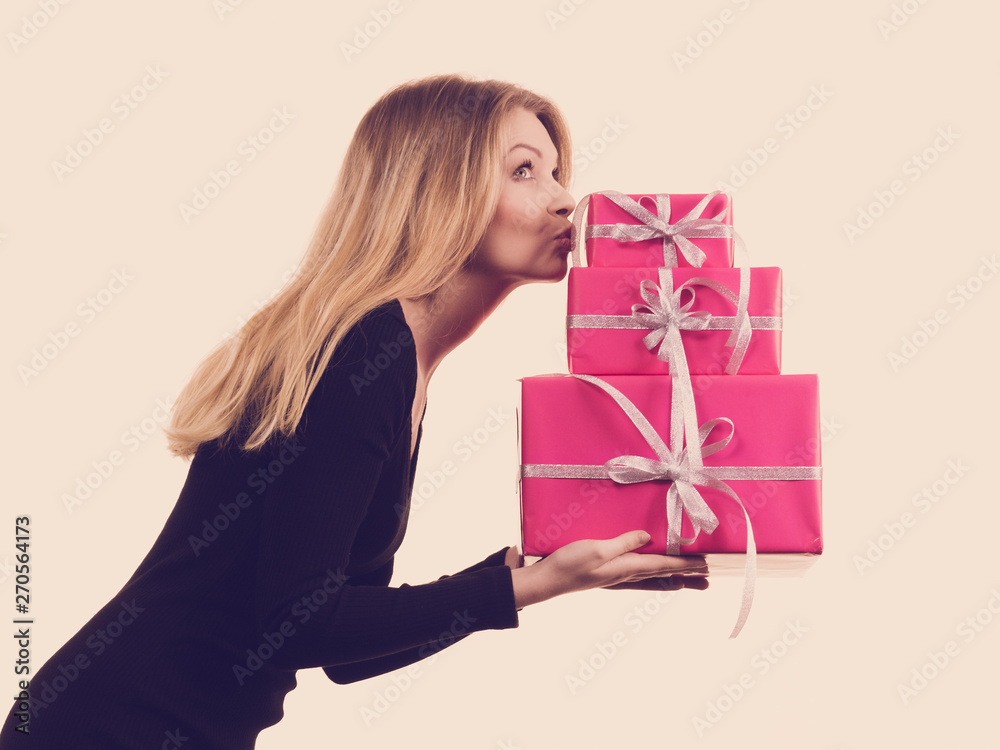Girl holding stack of pink gift boxes Girl holding stack of pink gift boxes