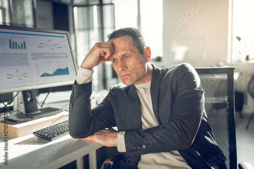 Handsome businessman feeling embarrassed after bad news photo