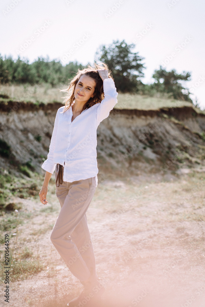 Beautiful and happy woman girl have fun and relax in summer. Portrait of a beautiful girl on the Planer near the cliff. Freedom for a walk Beautiful and happy woman girl have fun and relax in summer. Portrait of a beautiful girl on the Planer near the cliff. Freedom for a walk