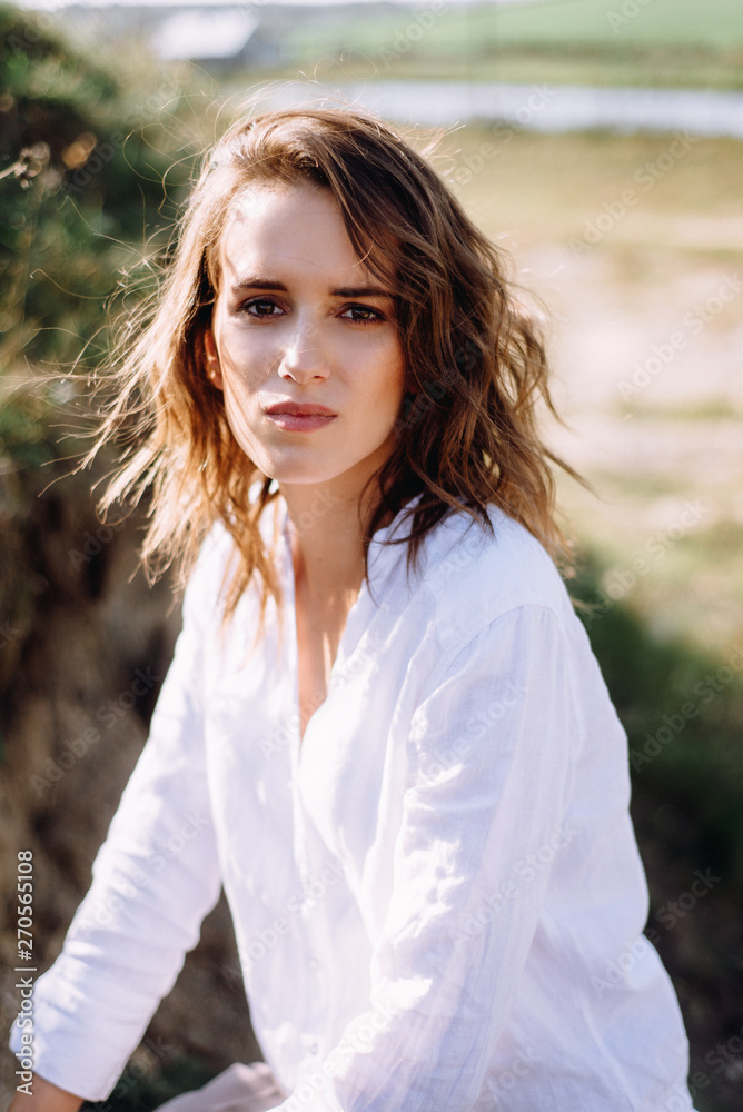 Beautiful and happy woman girl have fun and relax in summer. Portrait of a beautiful girl on the Planer near the cliff. Freedom for a walk Beautiful and happy woman girl have fun and relax in summer. Portrait of a beautiful girl on the Planer near the cliff. Freedom for a walk