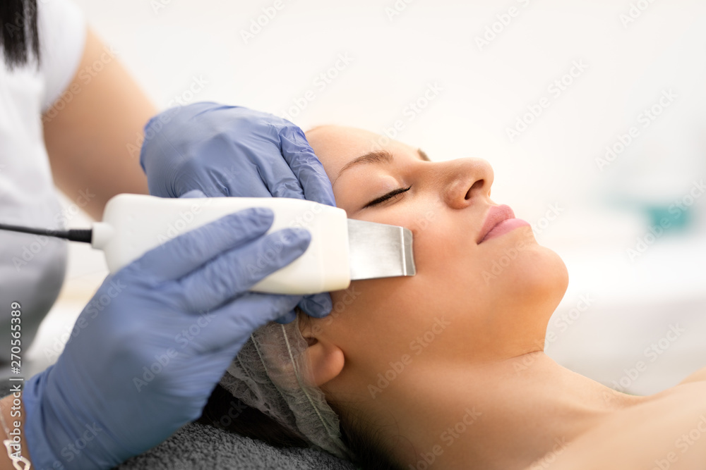 Beautiful woman receiving skin cleansing procedure in cosmetologically clinic Beautiful woman receiving skin cleansing procedure in cosmetologically clinic